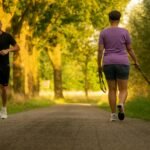 The setting is in a park. A man is jogging (forward facing). A woman is walking her dog (back facing). They are passing each other.