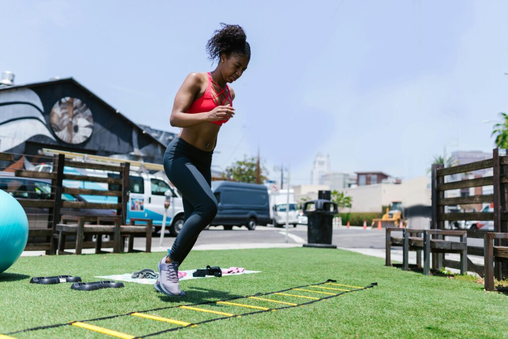 turbocharge your summer wellness - woman exercises outdoors on a summer day doing agility drills