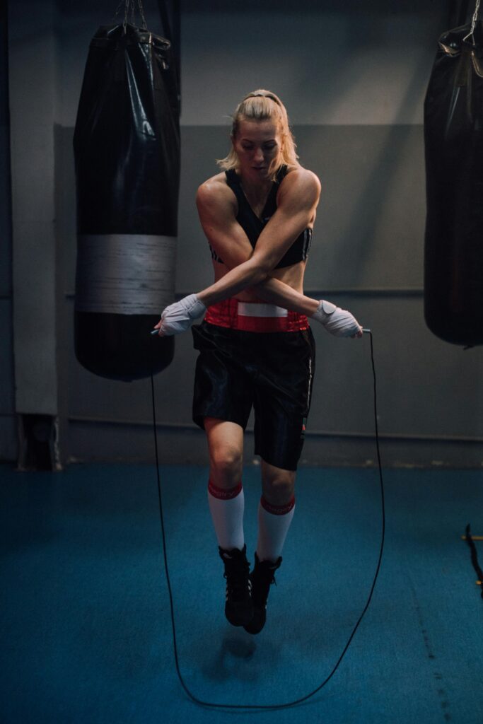 a female boxer jumps rope as part of her training routine