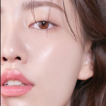 Glass Skin Korean Skincare Routine: half of an asian woman's face is shown emphasizing shiny, dewy skin and natural makeup