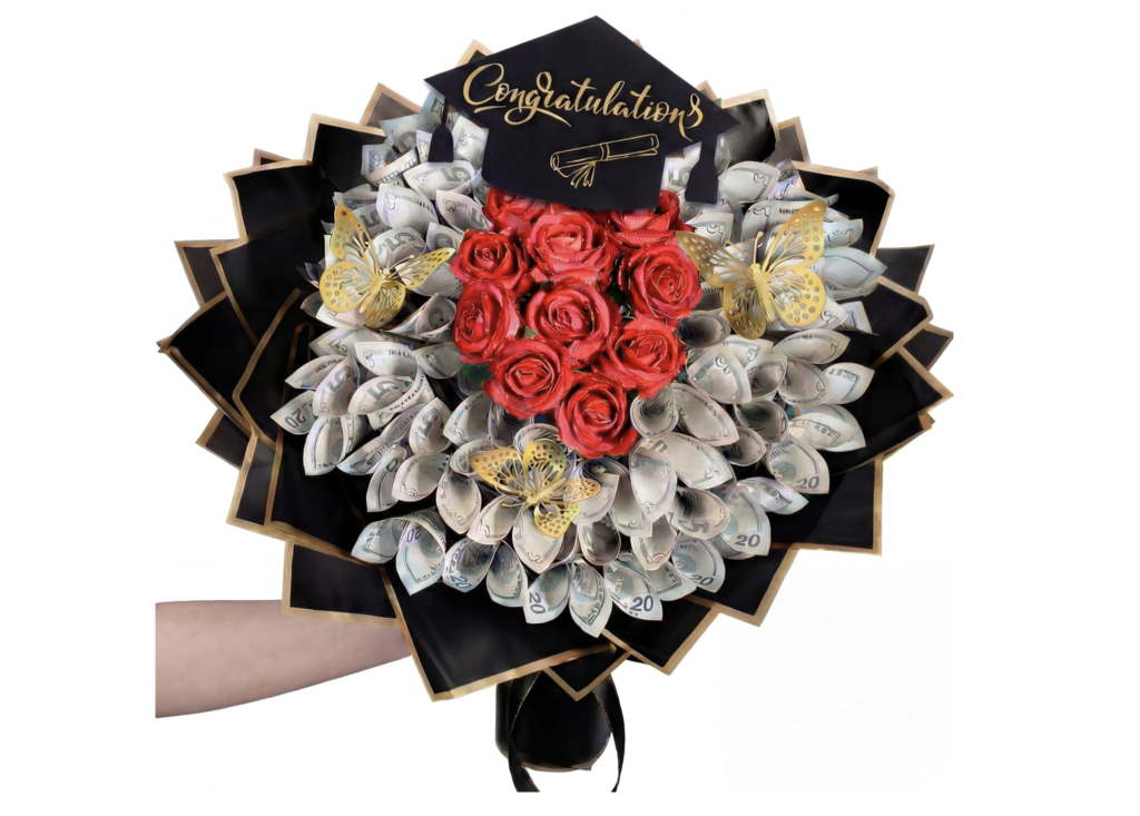 Graduation money bouquet with red silk roses, folded dollar bills, gold butterfly accents, and a black mortarboard topper that reads Congratulations, held against a white background.