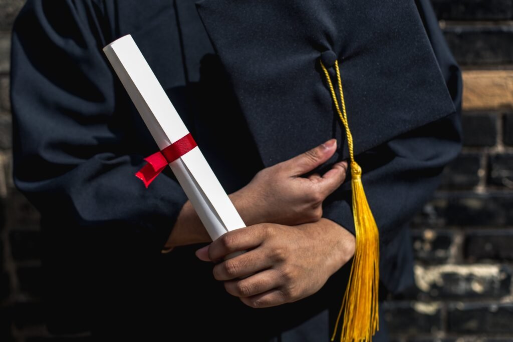 funny yearbook quotes: hands of a graduate outside holding graduation cap and diploma
