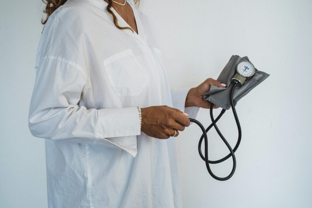 medical personnel holds a blood pressure cuff in her hands