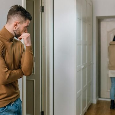 does everyone deserve a second chance - a couple experiencing a breakup. the woman is walking out. the man is watching her walk away. both are sad