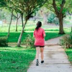 Blue Heron Blood Pressure Exercises - a woman outdoors walking in a park on a beautiful sunny day