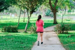 Blue Heron Blood Pressure Exercises - a woman outdoors walking in a park on a beautiful sunny day