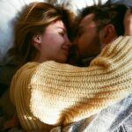cute good morning love quotes for him - a man and woman together in bed, fully clothed, hugging each other, with the sunlight coming through window