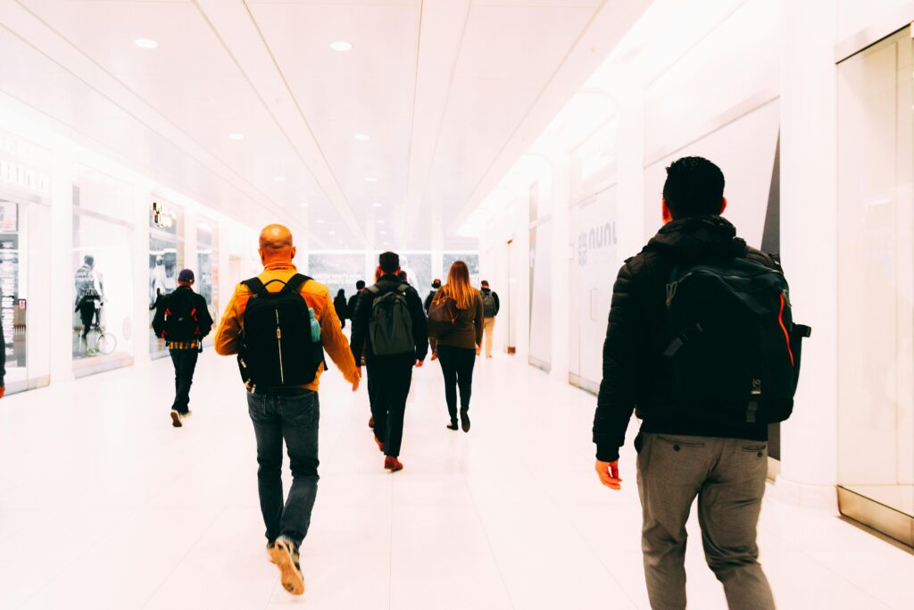 The best backpacks for middle school - students are walking down a school hallway with backpacks on their backs