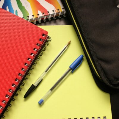 Amazon back to school savings - a pic of school supplies (2 pens, 2 notebooks, and a binder)