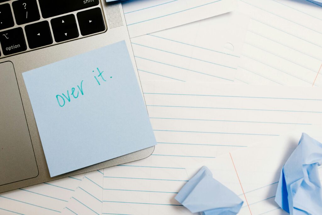how to overcome procrastination for students - a post-it note with the word, "over it" written on it