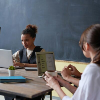 popular back to school items - a 21st century classroom with 3 students on tech devices