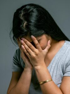 life lesson quotes - a woman holds her head in her hands as if defeated
