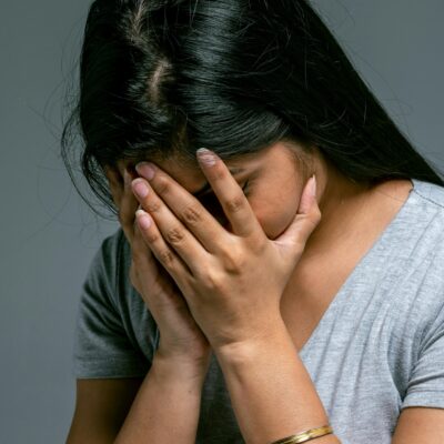 life lesson quotes - a woman holds her head in her hands as if defeated