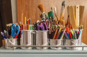 welcome back to school - tin cans full of various school supplies