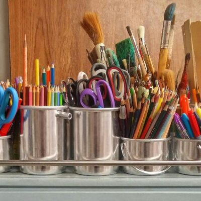 welcome back to school - tin cans full of various school supplies