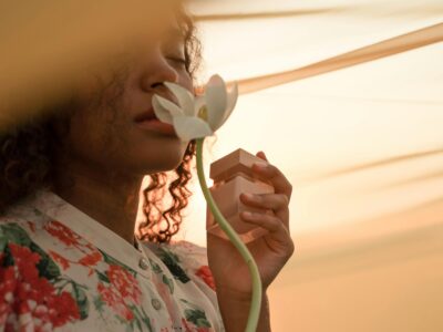 30 day glow up challenge to becoming her - a woman smells a rose in solitude