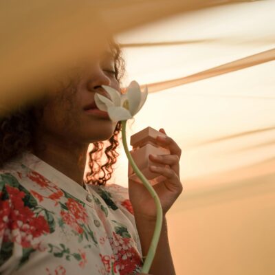 30 day glow up challenge to becoming her - a woman smells a rose in solitude