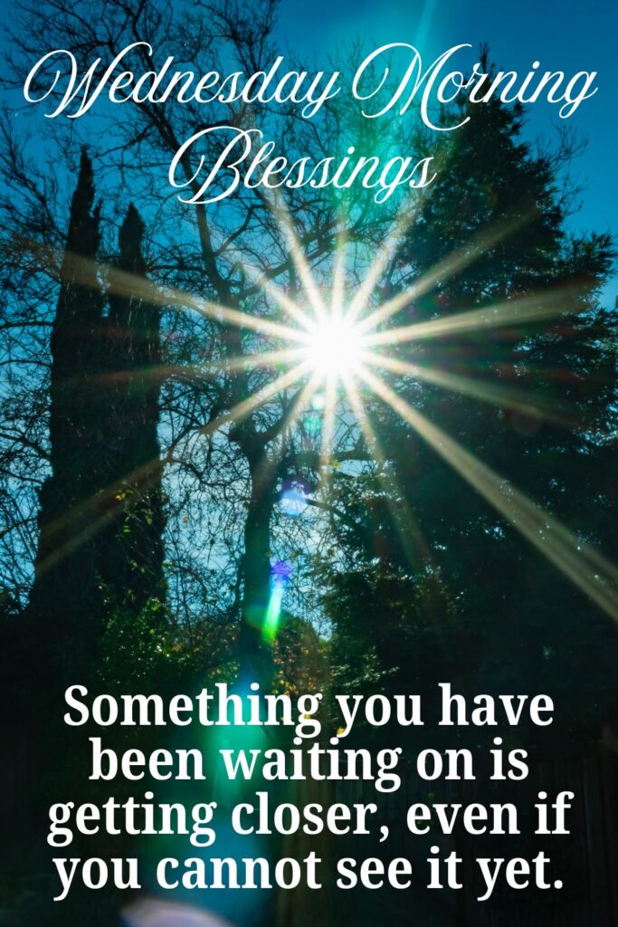 Pinterest-style image with sunlight bursting through tall trees, creating a bright starburst effect and lens flare. Text reads “Wednesday Morning Blessings” and “Something you have been waiting on is getting closer, even if you cannot see it yet.”