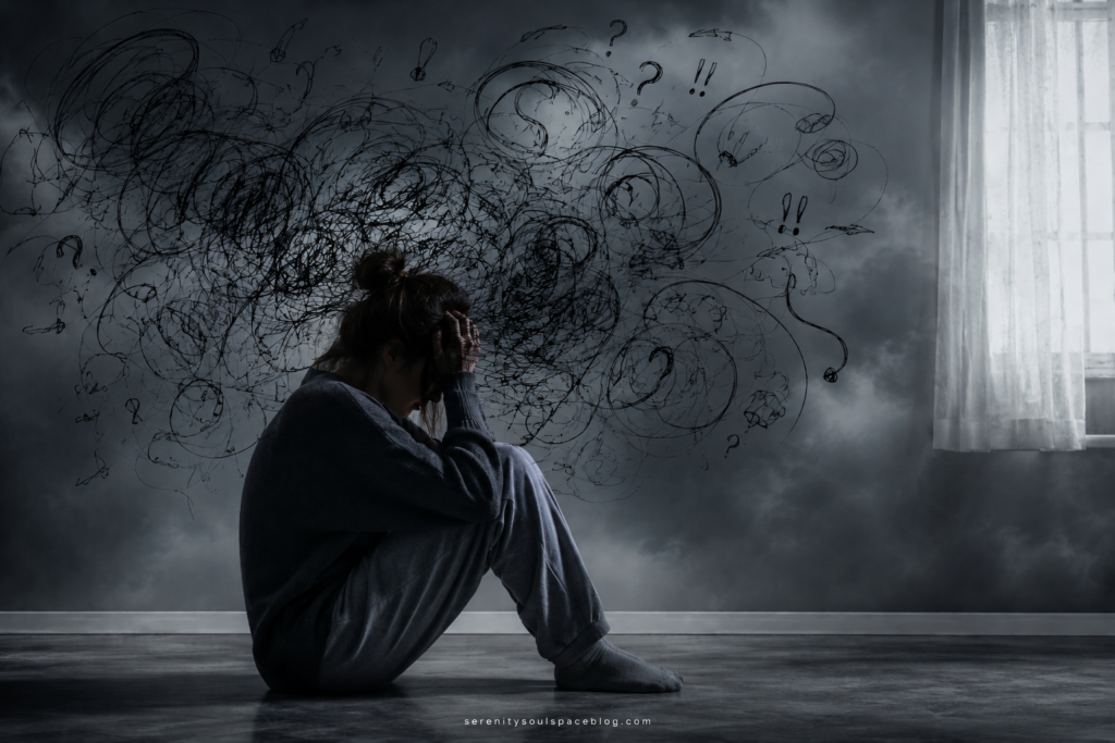 Woman sitting alone on the floor in a dark room with her head in her hands while chaotic black scribbles swirl around her, symbolizing worry, anxiety, overthinking, and emotional overwhelm. Soft light streams through a nearby window, creating a dramatic and realistic mental health concept image.